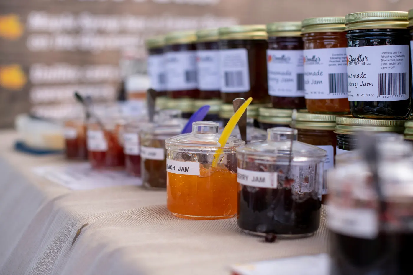 Rows of homemade jam jars on a market stall, illustrating the paradox of choice